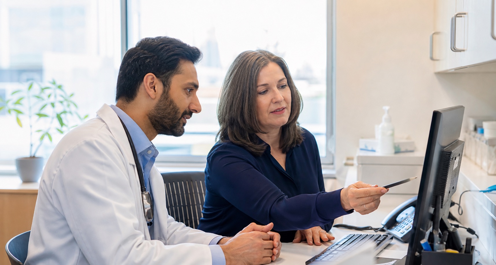 Ontario physician and clinic administrator reviewing a billing workflow together
